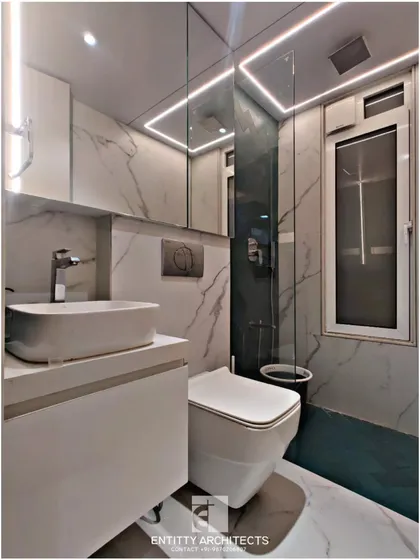Even compact bathrooms can feel luxurious. I used large format marble-patterned tiles and strategic LED strip lighting to create a sense of space and sophistication in this minimalist bathroom design.