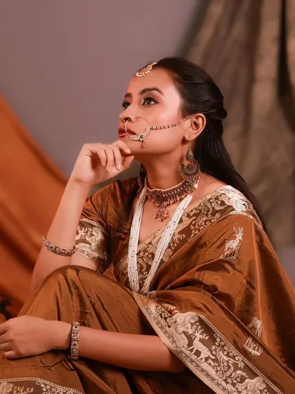 A thoughtful and elegant portrait inspired by classic Indian aesthetics. The warm lighting and traditional props create a rich, cinematic feel.
