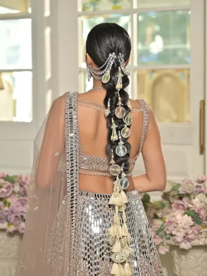 This shot provides a clear and direct view of the full braid, showing the symmetry and craftsmanship involved in creating such a detailed look for a jewellery campaign.