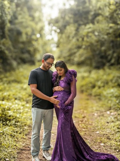 An intimate moment between the couple on a path in the woods. The focus is on their connection and the beautiful, natural surroundings.
