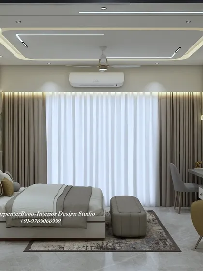 Another view of the bedroom, showing the large window and the comfortable seating area, making it a multi-functional and relaxing space.