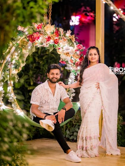 A couple enjoys a moment on our floral swing, a beautiful and romantic spot in the garden.