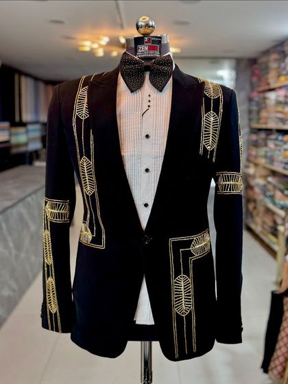 Another angle of the black and gold tuxedo, showing how the embroidery extends down the sleeves. This is a statement piece from every viewpoint.