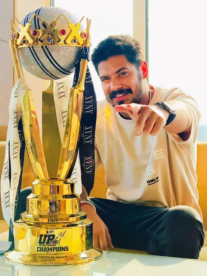 A more casual, off-field portrait with the championship trophy. These relaxed shots add a personal touch to the victory narrative.