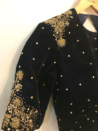 An alternate angle of the exquisite hand embroidery on a black velvet blouse, highlighting the craftsmanship and detail.