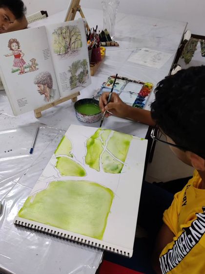 A teen student learns to draw and paint a complex tree structure, focusing on the fundamentals of form and color.