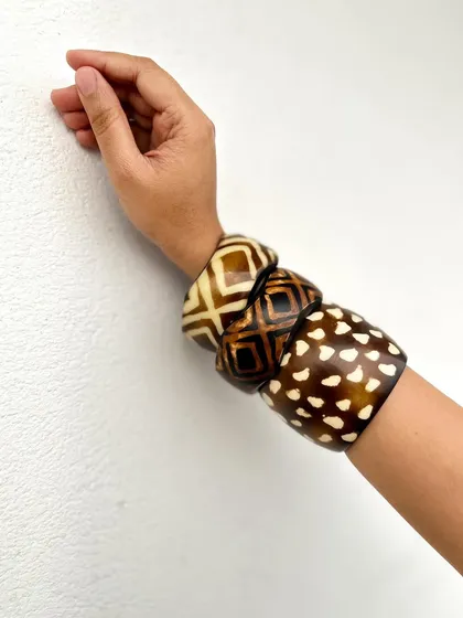 A close-up of the other stack of bangles, featuring different geometric and animal-style prints.