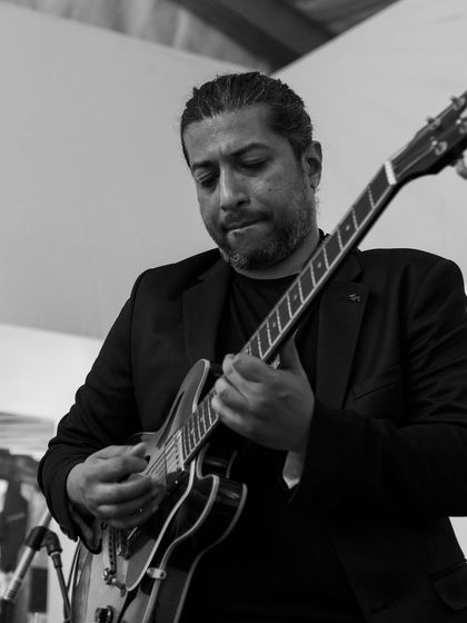 Adil Manuel focused on his guitar solo. The level of musicianship in our band is what sets our performances apart.