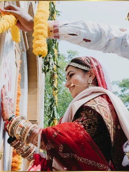 The bride performing a traditional ritual, her smile radiating happiness and grace.