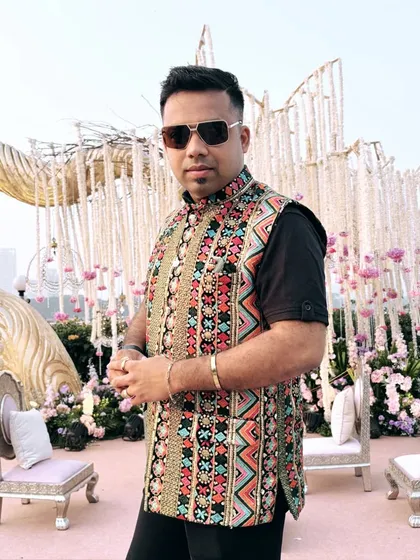 A confident pose in my colorful jacket. My outfits are chosen to reflect the joy and vibrancy of the occasions I host.