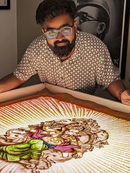 A glimpse of a colorful Ganpati sand art piece, with the deity surrounded by a radiant aura.
