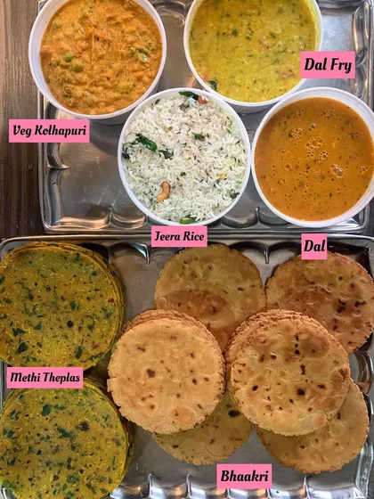 A perfect Sunday meal. This order included Veg Kolhapuri, Dal Fry, Jeera Rice, Methi Theplas, and Bhaakri, a wholesome and flavorful combination.