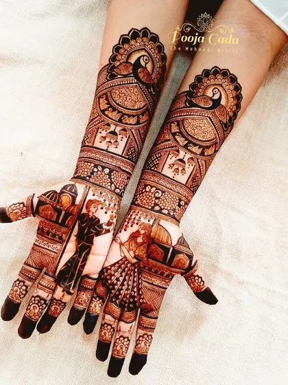 A full view of a gorgeous engagement design. The artwork includes dancing figures on the palms, set against an architectural backdrop, with large, elegant peacocks on the forearms.