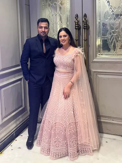 This happy client chose a beautiful pink lehenga with a feather-detailed cape for her event. It’s a perfect blend of traditional and modern style.