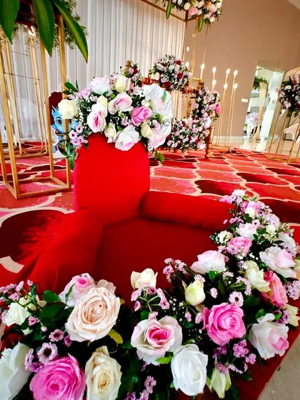 A close-up of a vibrant floral arrangement made with pink and white roses, used as part of the floor decor for the ceremony.