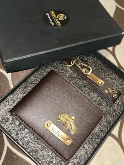 A dark brown leather wallet and keychain combo, personalized for 'Soham' with car and bike charms.
