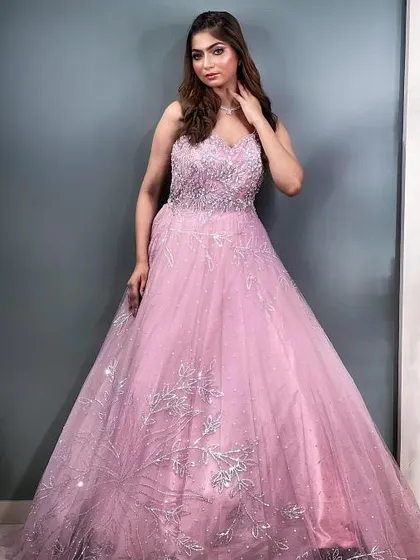 A full-length view of this breathtaking pink gown, perfect for making a grand entrance at your engagement or reception.
