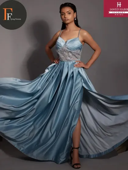 A full shot of the model in the blue gown, demonstrating a complete and professional fashion look.