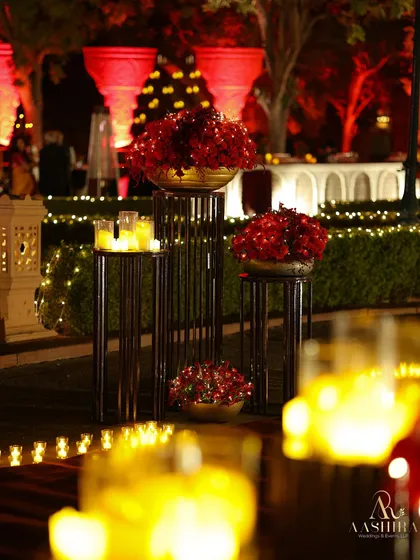 Another view of the tiered floral stands, with the candle wall in the background creating a layered and opulent look.