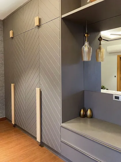 A detail shot of the custom wardrobe in the grey-themed bedroom. The chevron pattern is a client favorite, and we paired it with simple, light wood handles for a clean look.