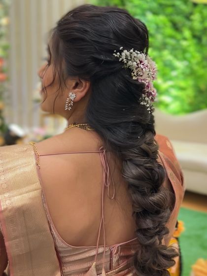 A back view of the romantic pull-through braid, showing its texture and how it complements the client's look.