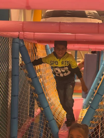 Another happy moment captured in our soft play jungle gym. The netted pathways provide a safe way for kids to climb and explore.