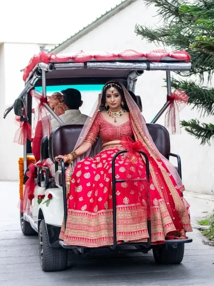 The bride's unique exit in a decorated golf cart. This photo captures a fun and modern twist on the traditional wedding vidai.