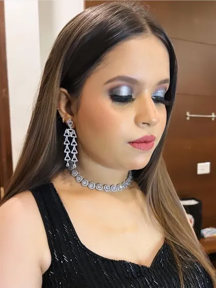 A bold and glamorous party look featuring a silver and black smokey eye. I teach my students how to create dramatic eye makeup that stands out, including techniques for blending, creating sharp lines, and applying lashes for maximum impact.