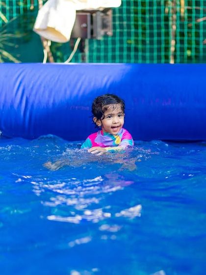 A sweet photo of a little girl enjoying a swim. I ensure the pool environment is safe and welcoming for even the youngest guests.