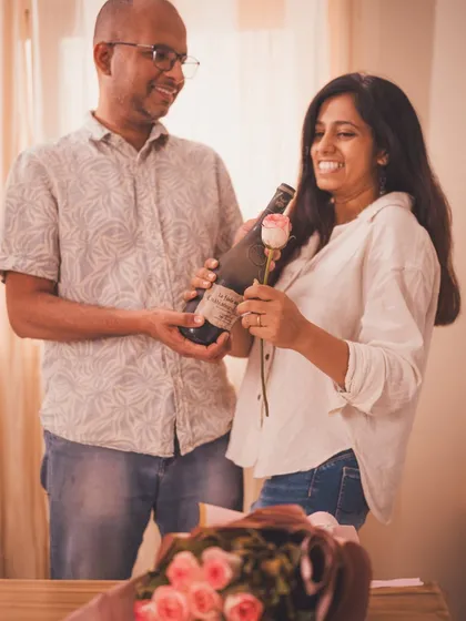 A candid moment of a couple sharing a bottle of wine. This lifestyle shot feels authentic and captures a genuine connection.