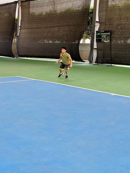 A junior player demonstrates dynamic movement and readiness between shots. Proper footwork and court positioning are fundamental skills we emphasize in our training.