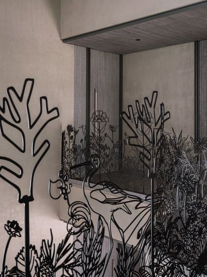 Another angle of the nature-inspired metal railing, this shot emphasizes how the piece interacts with the home's interior architecture, creating layers of visual interest.