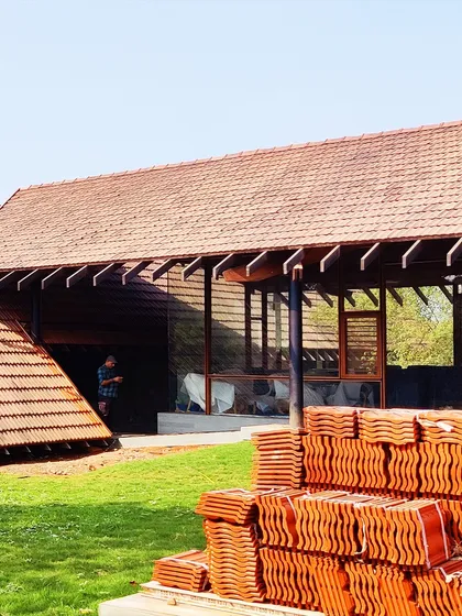 The final touches are being put on our Alibaug residence. Stacks of traditional Mangalore tiles wait to be laid, a key material choice that connects the home to the local architectural vernacular.