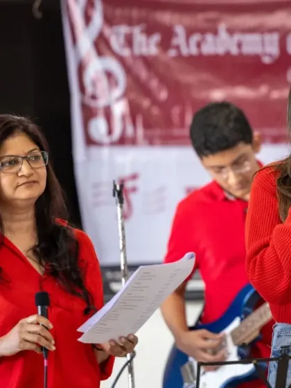 A teacher and student sing a duet, showcasing the collaborative and supportive learning environment we foster. Our teachers often perform alongside students, providing guidance and encouragement on stage.
