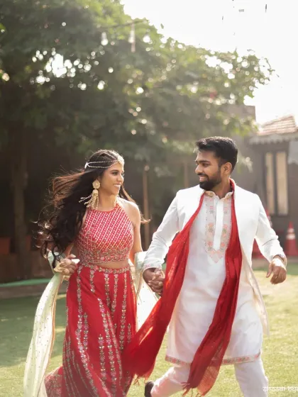 A candid shot of the couple running hand-in-hand, full of energy and happiness.