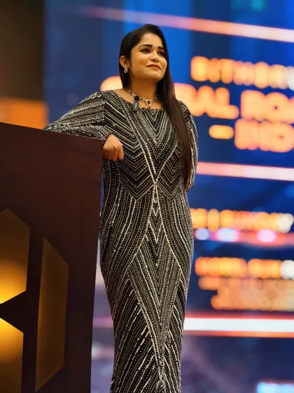 Standing tall and ready to celebrate success at the BitHarvest Global Roadshow. I believe an anchor's presence should reflect the prestige of the awards being presented.