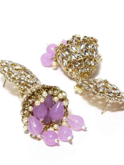 A detailed shot of the purple kundan jhumkas, perfect for those who love a pop of color.