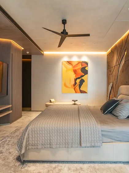 A full view of the bedroom at Lodha Worldview, where a custom textured headboard wall creates a dramatic focal point. The design balances opulence with warmth, steering clear of ostentation while embracing an aura of refinement.