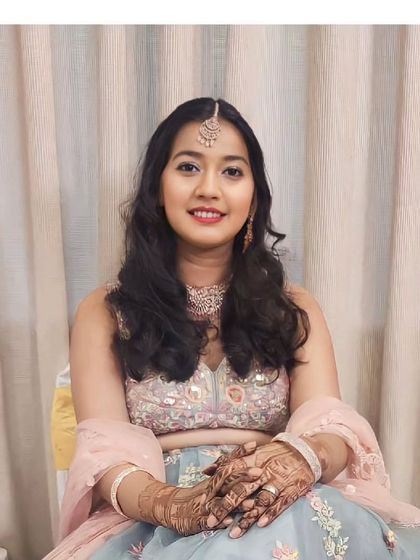 Our client looks serene and elegant in this pastel blue and pink floral lehenga. It's a wonderful choice for a daytime engagement or roka ceremony.