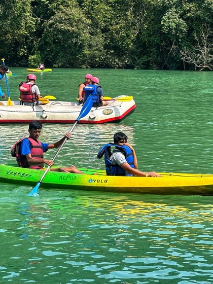 Two students kayaking on the calm stretches of the river.