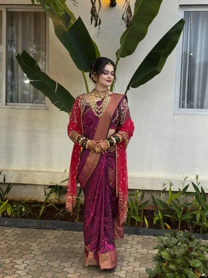 A full view of a perfectly draped bridal Navari saree. For this bride, I used a rich wine-colored silk saree and a contrasting red shawl, creating a royal and timeless look for her wedding.