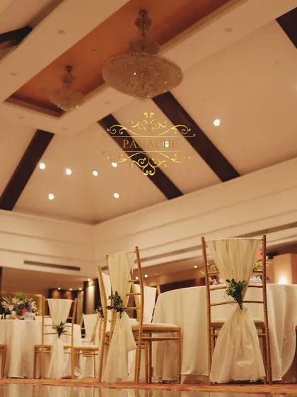 A low-angle shot of the guest seating, highlighting the chandeliers in the banquet hall.
