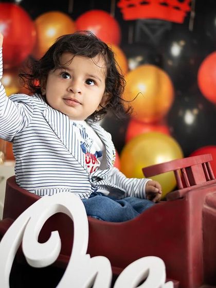 A playful shot from our king-themed session, with the birthday boy sitting in a toy car.