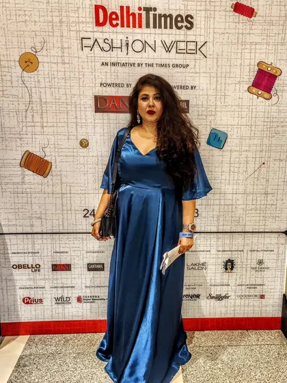 Attending Delhi Times Fashion Week in one of my own designs. This royal blue satin gown features a slimming empire waist and flowing flutter sleeves, offering a look of effortless elegance.