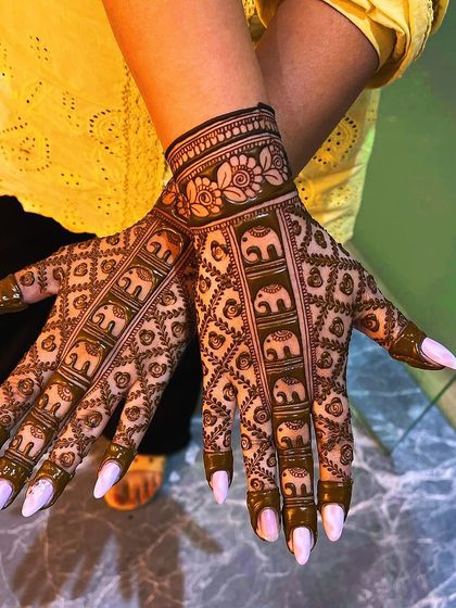 A clear view of the elephant procession design. The symmetry and detail in each elephant motif showcase the precision and care I put into my traditional henna work.