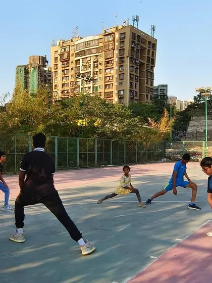 A coach leads a stretching session with young players. Join our community to take your skills to the next level.