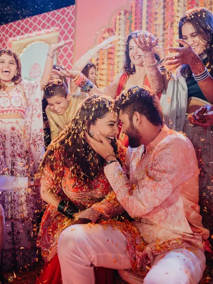 An intimate and joyful Haldi moment. The couple is surrounded by their family, all sharing a laugh as they are showered with flower petals. I focus on creating spaces that foster these beautiful connections.
