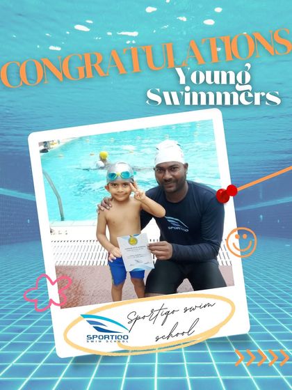 A young boy flashes a victory sign while holding his certificate, a testament to his hard work and newfound confidence in the water.
