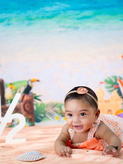 A beach-themed half-birthday is a fun way to mark six months. This little one is enjoying tummy time on our studio "sand."