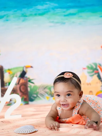 Celebrating a half-birthday with a beach theme. This little one is enjoying some tummy time on the sand.